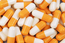 Yellow And White Medical Capsules On The One Heap