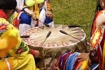 indians around a drum at a pow wow