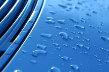 Close-up Of Raindrops On Metallic Vehicle Panel