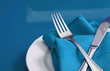 A colorful table set with plate, knife, fork and napkin