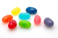 8 Different Color Jelly Beans Over White Background