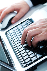 Canvas Print - Vertical image of human hands typing a letter