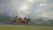 Cowboys riding the range. Front lit with storm clouds