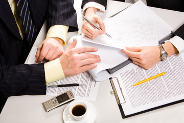 Canvas Print - Business people’s hands on the table with a coffee and a cell 