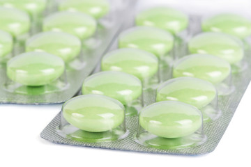 Wall Mural - blister package of green pills isolated on white