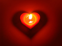 Burning Candle With Heart Shape Shadow