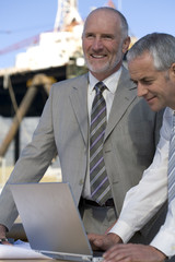 Sticker - Oil rig engineers studying plans in the harbor