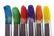 The Tips Of Three Colorful Paintbrushes Ready To Be Used.