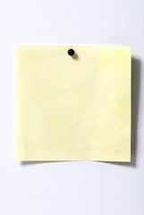 A small yellow post it ready to fill out. white background