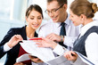 © pressmaster - Image of three business people looking at business plan