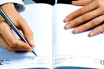 Sticker - Image of writing instrument in human hands over notepad