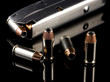 40 caliber bullets and clip on reflective black background