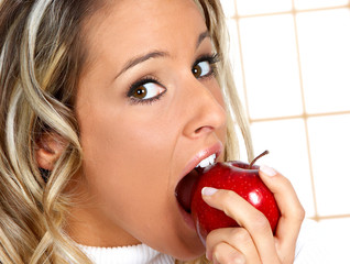 Wall Mural - Beautiful young woman eating the red apple. .