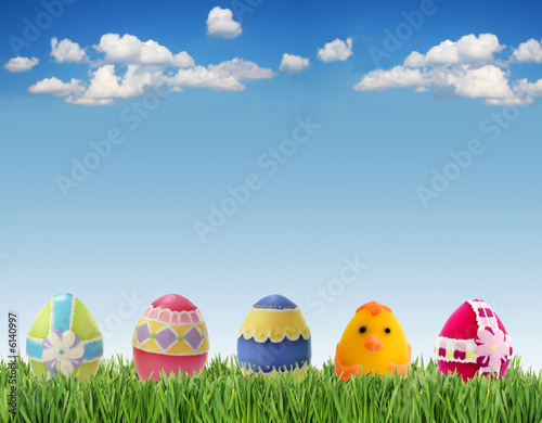 Easter eggs in grass on sky background