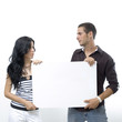 © roxxyphotos - Young couple holding a blank banner - isolated