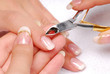 Nail salon - Cut cuticle on the female forefinger