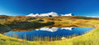 Snowy mountains reflected in lake, Plateau Ukok