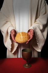 Wall Mural - Jesus hands holding the bread at the Communion table