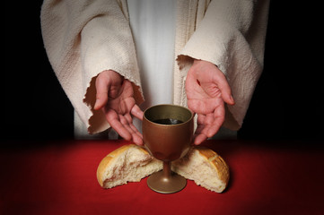 The hands of Jesus offering the Communion wine and bread