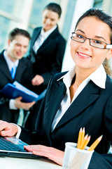 Sticker - Successful young woman with glasses looking at camera 