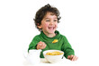 young boy eating cornflakes isolated on white
