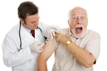 Senior man at the doctor's office, surprised by  injection. 