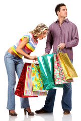 Wall Mural - shopping couple smiling. isolated over white background.