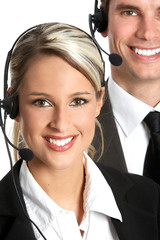 Canvas Print - Smiling  business people  with headsets. Over white background .