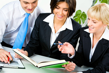 Canvas Print - Portrait of three business people planning work in the office