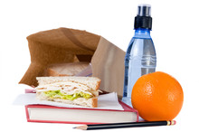 A Brown Bag School Lunch, With Fruit And Water