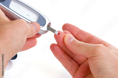Fotografía Diabetic is doing a glucose level finger blood test.