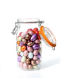 glass jar with chocolate easter-eggs, on white