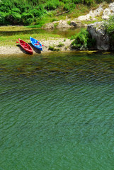 Wall Mural - Kayaks on river bank