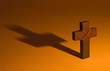 Moody wooden cross casting long shadow