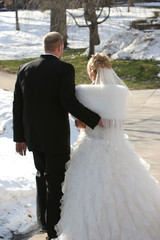 Wall Mural - bride and groom walking hand on back