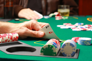 Man checking cards during poker game