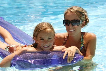 woman and little girl  in a swimming pool