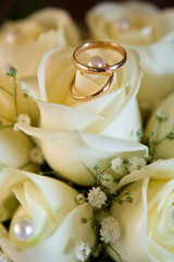 Wall Mural - wedding rings (close-up on wedding bouquet from yellow roses)