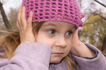 girl  with her ears shut