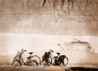 Fototapete - Italian old-style bicycles leaning against a wall 
