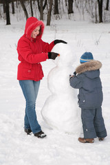 Wall Mural - mother and child make snowman