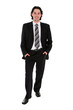 © pikselstock - Businessman standing with hands in pockets