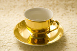 Fototapeta Maki - Golden coffee cup