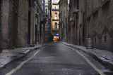 Fototapeta Uliczki - Looking down a long dark back alley