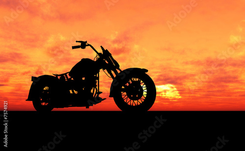 Naklejka dekoracyjna Motocykl na wzgórzu podczas zachodu słońca