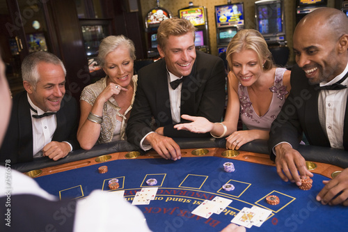 фотография Group of friends playing blackjack in casino
