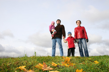 Wall Mural - family stand on meadow at autumn