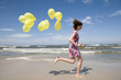 © Gorilla - Teenager playing with balloons on the beach