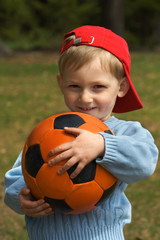 Wall Mural - Happy kid with a ball