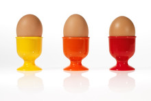 Three Eggs In Colorful Egg Cups